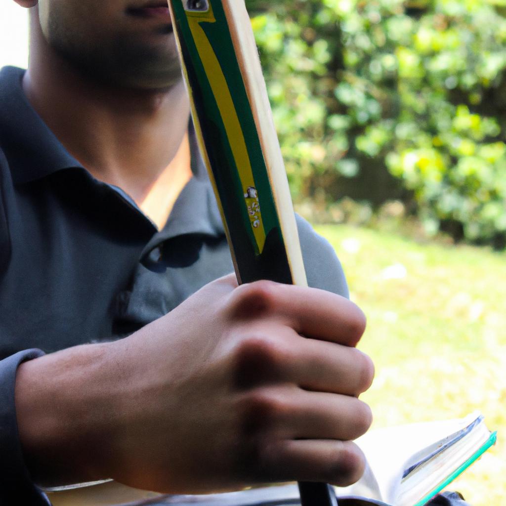Person holding cricket bat, studying