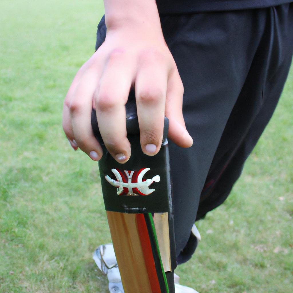 Person demonstrating cricket equipment usage